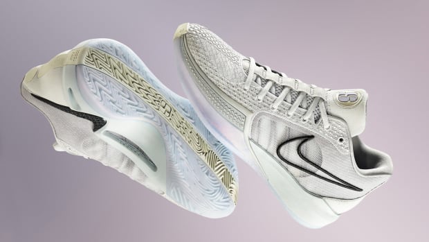 Side view of Sabrina Ionescu's white and black Nike basketball shoes.